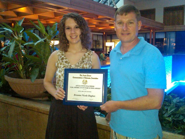 Breanne Hughes, chapter winner of the STEM Teachers for Americas Future Scholarship, receives check and certificate from Col. Andy Thomson (Ret.), board member, in July.